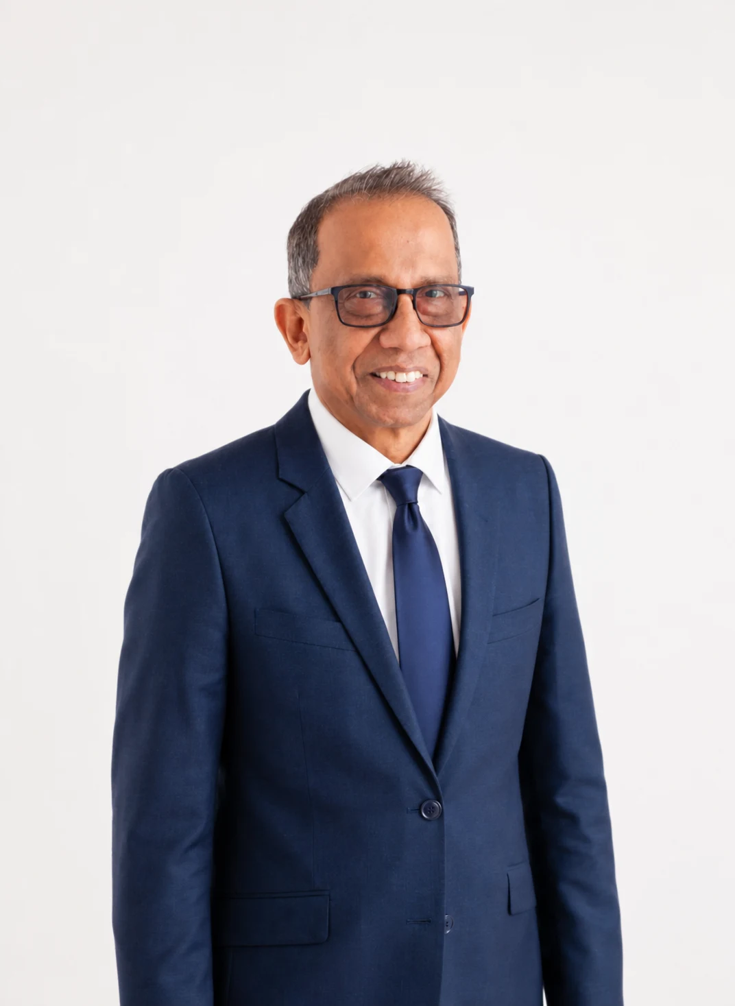 Nalin Wijetilleke standing in a navy suit and tie